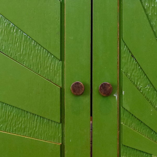 detail of handles and carving on green unit doors