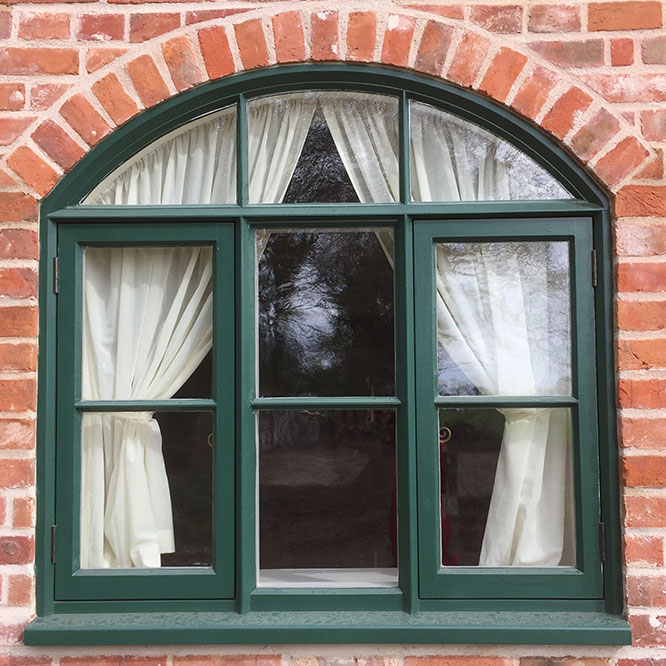 view of a green window with arch at the barn house